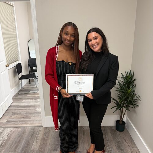 A Winners Crest Agency team member being presented with a certificate of achievement